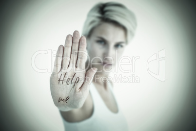 Composite image of angry pretty blonde showing her hand