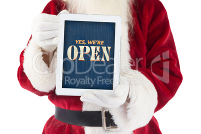 Composite image of santa claus showing tablet pc