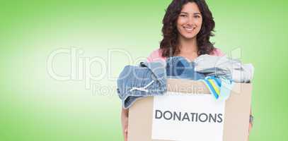 Composite image of volunteer holding clothes donation box