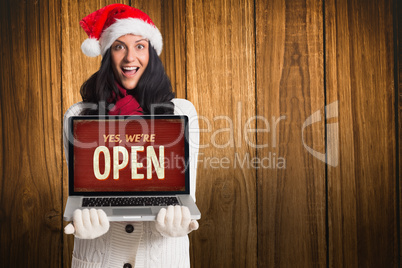 Composite image of smiling woman holding a laptop