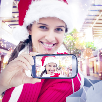 Composite image of hand holding smartphone showing