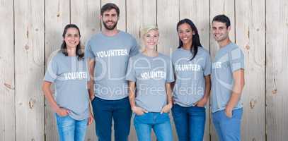 Composite image of volunteers friends smiling at the camera
