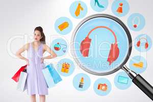 Composite image of elegant brunette with shopping bags