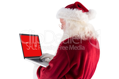 Composite image of santa claus uses a laptop