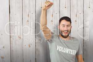 Composite image of portrait of cheerful volunteer