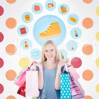 Composite image of pretty young blonde holding shopping bags