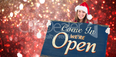 Composite image of festive blonde showing a blank banner