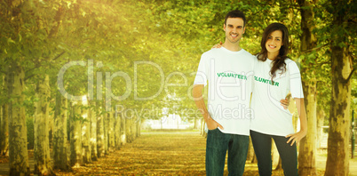 Composite image of two cheerful people wearing volunteer tshirt