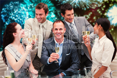 Composite image of smiling business team celebrating a success w