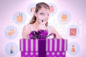 Composite image of woman looking through a magnifying glass
