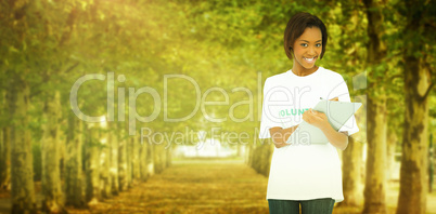 Composite image of smiling volunteer woman holding clip board