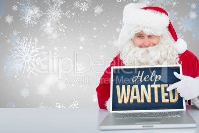 Composite image of santa using laptop