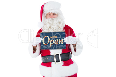 Composite image of smiling santa claus holding page