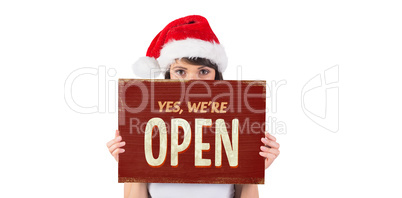 Composite image of pretty santa girl smiling at camera with post