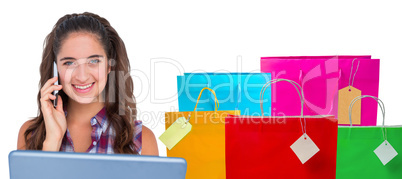 Composite image of happy pretty brunette using tablet computer a