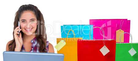 Composite image of happy pretty brunette using tablet computer a