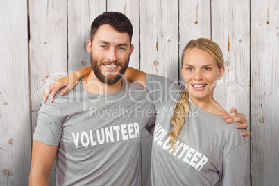 Composite image of portrait of colleagues with arms around stand