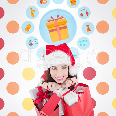 Composite image of smiling brunette holding shopping bags full o