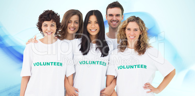 Composite image of group of people wearing volunteer tshirt