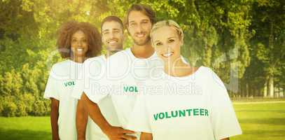 Composite image of smiling volunteer group