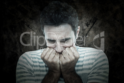 Composite image of upset man with hands on mouth