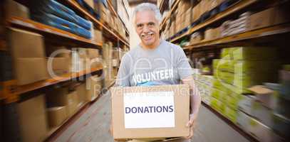 Composite image of happy volunteer senior holding donation box