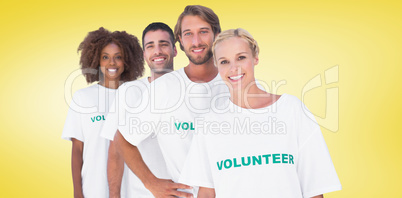 Composite image of smiling volunteer group