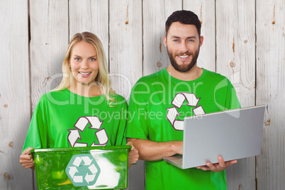Composite image of portrait of smiling volunteers in recycling s