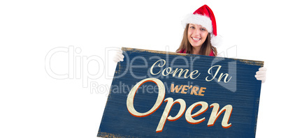 Composite image of festive blonde showing a blank banner