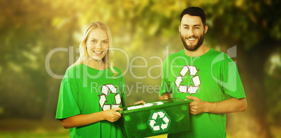 Composite image of portrait of smiling volunteers carrying recyc