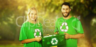 Composite image of portrait of smiling volunteers carrying recyc