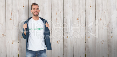 Composite image of portrait of a smiling young male volunteer