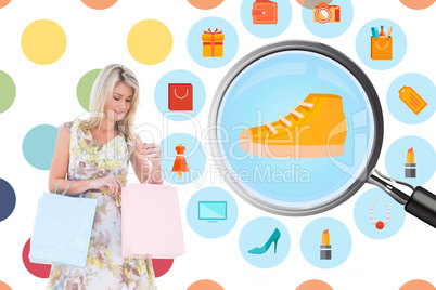 Composite image of elegant blonde with shopping bags