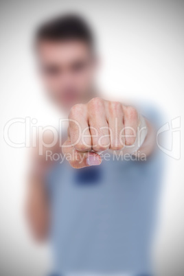 Composite image of portrait of handsome man punching in the air