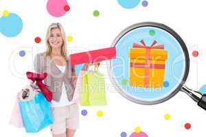 Composite image of happy blonde with shopping bags and gifts