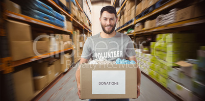 Composite image of portrait of man holding clothes donation box