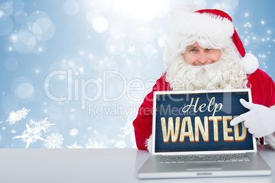 Composite image of santa using laptop