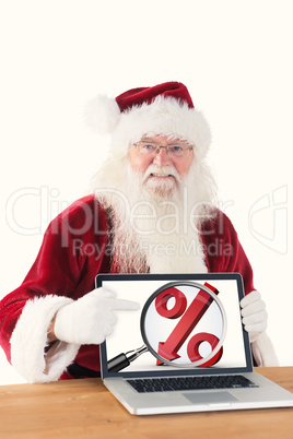 Composite image of happy santa showing laptop screen