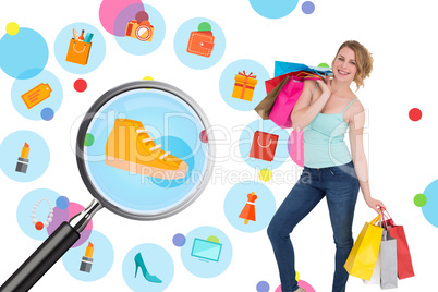 Composite image of smiling blonde woman standing with shopping b