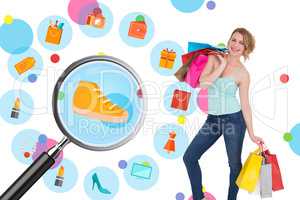 Composite image of smiling blonde woman standing with shopping b