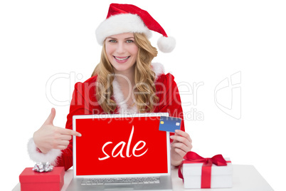 Composite image of woman with a credit card