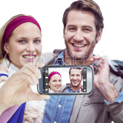 Composite image of hand holding smartphone showing