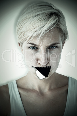 Composite image of angry woman looking at camera