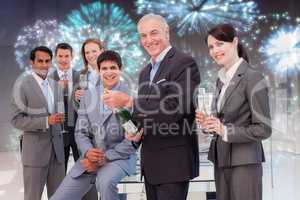 Composite image of businessman opening a bottle of champagne to