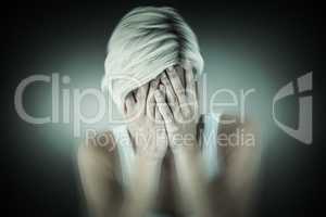 Composite image of sad blonde woman crying with head on hands