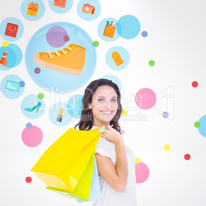 Composite image of pretty brunette with shopping bags