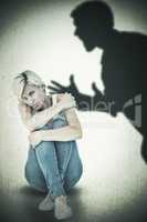 Composite image of depressed blonde looking at camera