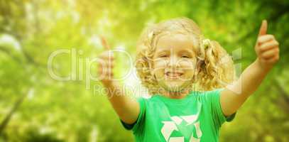 Composite image of happy little girl in green with thumbs up