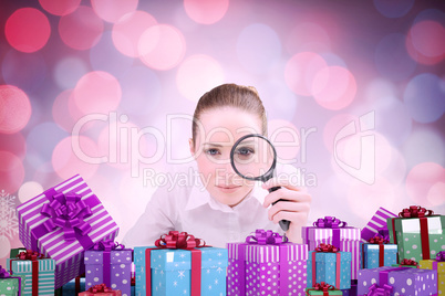 Composite image of businesswoman typing and looking through magn