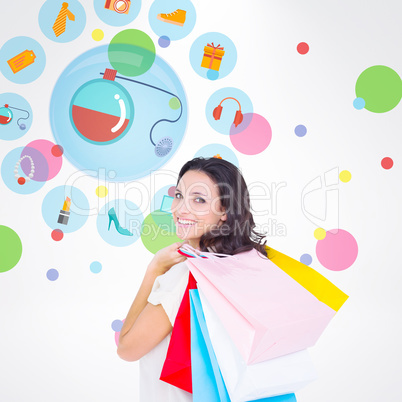 Composite image of pretty brunette with shopping bags